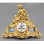 A Louis XV style gilt bronze 8 day mantel clock with Sevres style inset panels