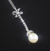 A 1920's platinum, diamond and cultured pearl set drop pendant, with millegrain setting, on a