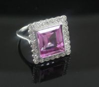 A mid 20th century 18ct white gold, pink sapphire and diamond cluster dress ring, the rectangular