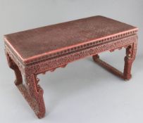 A Chinese cinnabar lacquer small table, 18th / 19th century, carved with Swastika motifs and flowers