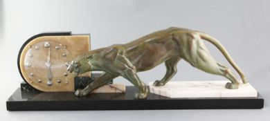 An Art Deco three colour marble and bronzed spelter mantel timepiece, modelled with a prowling