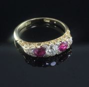 A 20th century 18ct gold and graduated five stone ruby and diamond half hoop ring, size Q.