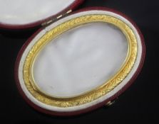 A 19th century gold mounted glazed oval miniature frame in fitted red leather case, 75mm.