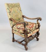 A 17th century Flemish style walnut armchair, with needlework back and seat, foliate carved frame,