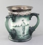 A Lenox Ceramic Art Company golf three handled mug, c.1905, signed W. Clayton, painted in green