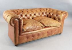 A pair of 1930's buttoned pale russet leather Chesterfield settees, W.5ft 9in. D.3ft. H.2ft 5in.