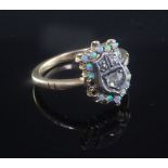 An Edwardian 18ct gold, white opal and rose cut diamond set shield shaped ring, missing two opals,