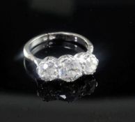 A mid 20th century white and three stone diamond ring, the adjustable shank with hinged shoulders