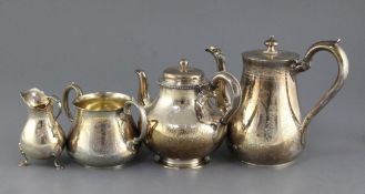 A matched Victorian four piece silver tea and coffee set, with engraved foliate decoration,