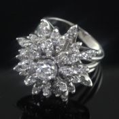 A 14ct white gold and diamond "snowflake" cluster dress ring, with an approximately estimated