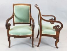 A pair of French Empire style mahogany armchairs, stamped Bouchard, with scroll arms, on sabre legs,