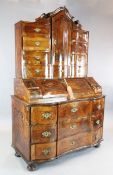 An 18th century South German inlaid walnut bureau bookcase, of serpentine form, W.4ft 3in. D.2ft