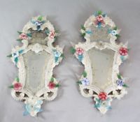 A pair of Venetian glass cartouche shaped wall mirrors, applied with Murano type coloured glass