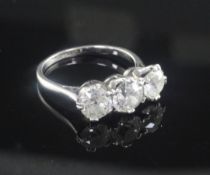 A mid 20th century platinum and three stone diamond ring, the three stones with an approximate total