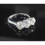 A mid 20th century platinum and three stone diamond ring, the three stones with an approximate total