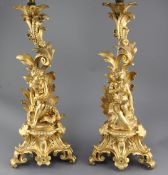 A pair of 19th century French ormolu lamp bases, modelled with foliate scrolls and seated youths,