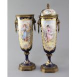 A pair of Sevres style porcelain and ormolu mounted vases and covers, c.1900, each painted with