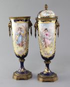 A pair of Sevres style porcelain and ormolu mounted vases and covers, c.1900, each painted with