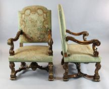 A pair of 19th century French Restauration style parcel gilt and carved beech armchairs, W.2ft