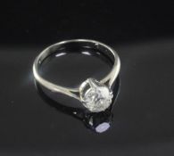 A white gold and solitaire diamond ring, the old mine cut stone weighing approximately in excess