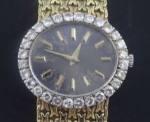 A lady's 18ct gold Piaget manual wind dress wrist watch with diamond set bezel, the oval dial with