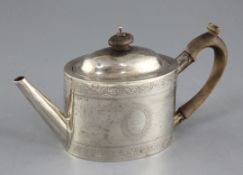 A George III silver oval teapot by Smith & Hayter, with engraved borders and armorial, London, 1797,