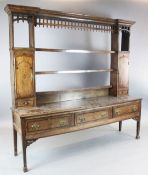 A George III mahogany banded oak dresser, the rack with later castellated frieze and three