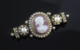 A Victorian gold, hardstone cameo and seed pearl brooch, the central oval cameo carved with the bust
