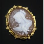 A yellow metal mounted oval cameo brooch, carved with the bust of a lady to dexter, with a bird in