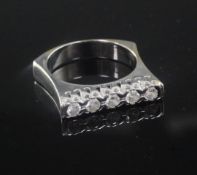 A modern white gold and five stone channel set diamond ring, size O.