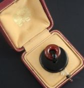 A cased mid 1930's French Cartier silver, black enamel and carnelian "plug" pill box, signed Cartier