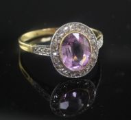 A gold, pink topaz and diamond oval cluster ring, with diamond set shoulders, size P.