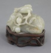 A Chinese celadon jade scroll weight, 17th / 18th century, carved as a recumbent phoenix grasping