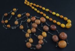 Two single strand amber bead necklaces, one with twenty nine graduated beads with chain links, the