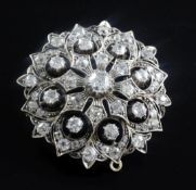 A Victorian gold, silver and diamond encrusted domed flowerhead pendant brooch, set with old mine