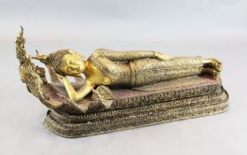A large Thai gilt and polychrome bronze reclining figure of Buddha, possibly Mandalay period, 19th