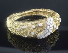 An 18ct yellow gold and diamond hinged bangle, of rod and sphere design, set with forty two