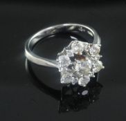A modern 18ct white gold and diamond cluster ring, size M.