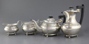 A 1930's four piece silver tea set by Viners Ltd, with engraved date and monogram, on claw and