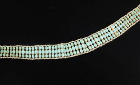 An Indian gold, seed pearl and turquoise choker necklace, set with three graduated rows of oval