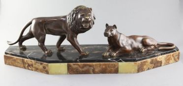 A French Art Deco group of a lion and lioness, on three colour marble plinth, width 30in.