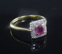 An early 20th century 18ct gold and platinum, ruby and diamond cluster ring, size P.