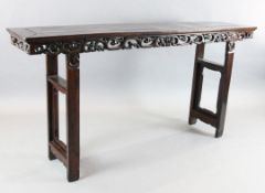 A Chinese rosewood (hongmu) altar table, late 19th century, with pierced scroll and fruit frieze, on