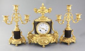 A late 19th century French bronze and ormolu clock garniture, with neo-classical cased clock, with