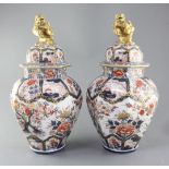 A pair of Imari octagonal vases and covers, by Samson of Paris, c.1900, each painted with pavilions,