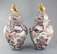 A pair of Imari octagonal vases and covers, by Samson of Paris, c.1900, each painted with pavilions,