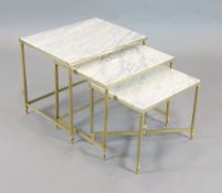 Attributed to Maison Bagues. A nest of three gilt brass occasional tables, with marble tops, largest