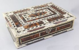 An 18th century Indo-Portuguese ivory, ebony and tortoiseshell games box, with trays of assorted