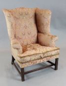 A George III mahogany wing armchair, with plain squared legs, W.2ft 10in. D.2ft 3in. H.3ft 8in.