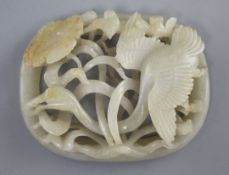 A Chinese pale celadon and russet jade plaque, Jin - Yuan dynasty, carved in high relief and pierced